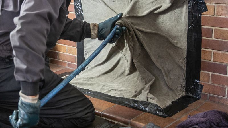 Chimney Sweep cleaning with covered brick firebox to protect home - Dunrite Chimney