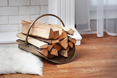 Stock photo firewood in basket with fur rug - Dunrite Chimney Centereach NY Firewood in basket with fur rug - Dunrite Chimney