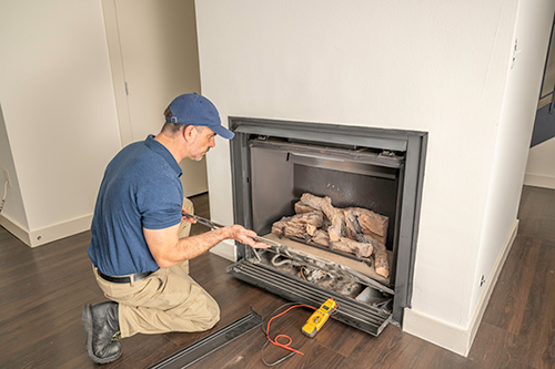 Man servicing fireplace insert - Dunrite Chimney
