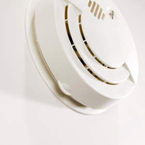 shite smoke detector on a white wall